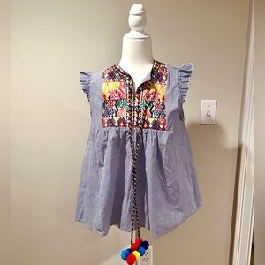 Adorable blue and white pin-striped ruffle sleeve shirt with embroidery.